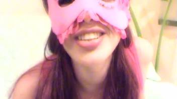 Brunette wearing pink mask and stockings having sex with a dog